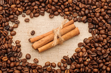 Obraz na płótnie Canvas handful aromatic coffee beans with cinnamon