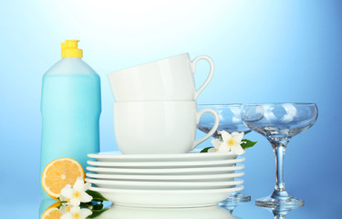 empty clean plates, glasses and cups with dishwashing liquid