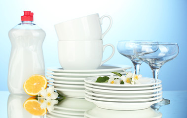 empty clean plates, glasses and cups with dishwashing liquid