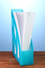 Blue tray for papers on blue background close-up