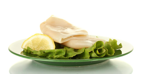 boiled squids with lettuce and lemon in the plate isolated