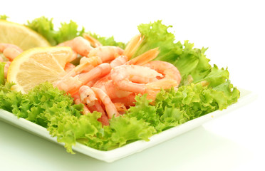 Boiled shrimps with lemon and lettuce leaves