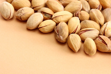 tasty pistachio nuts, on beige background