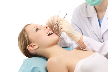 Obraz na płótnie Canvas A female dentist treating patient's teeth, isolated on white