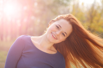 Young redhead woman in the park