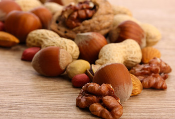 assortment of tasty nuts on wooden background