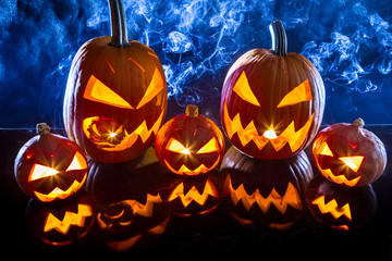Smoking group Halloween pumpkins on reflection table