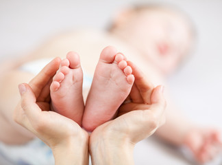 Obraz na płótnie Canvas ręce Matka gospodarstwa małe dziecko nogi