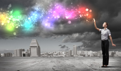 Businessman with colourful light beam in his hands