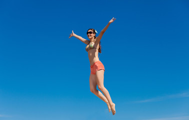 Obraz na płótnie Canvas Portrait of young woman in bikini at beach