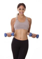 Healthy young woman in workout clothes uses hand weights.