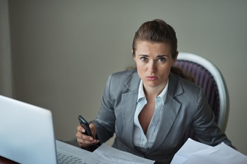 Sorrowful business woman working at desk