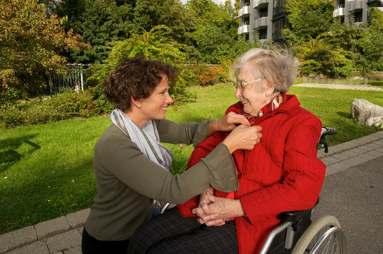 Seniorin im Rollstuhl mit Betreuerin