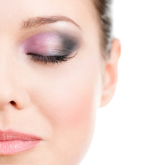 Close up of woman's half face with closed eye with makeup 