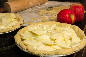 Apple pies ready for the oven with apples