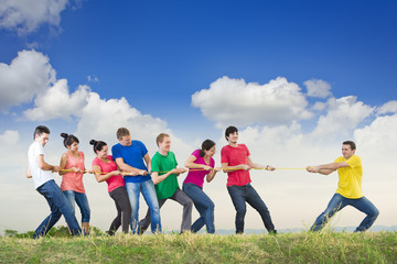 Group of young people pulling a rope
