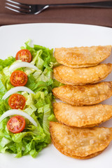 Tuna patties with lettuce salad in a plate