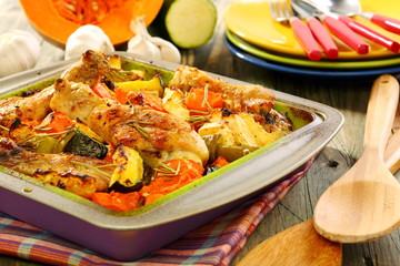 Chicken baked with pumpkin, zucchini, celery and rosemary.