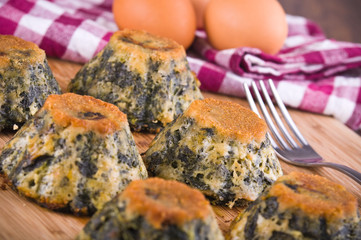 Spinach cakes on wooden cutting board.