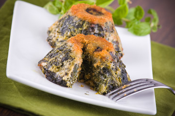 Spinach cakes on white dish.