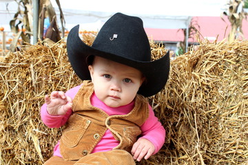 Adorable little girl in a cowboy hat