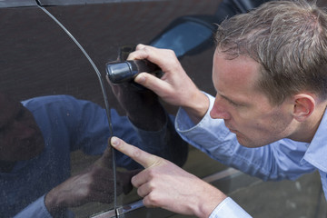 Man Checking His Car.
