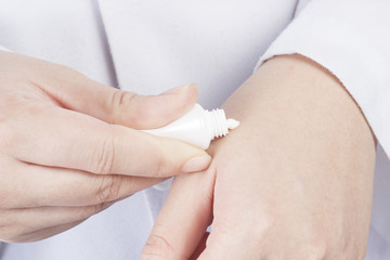 Woman hands holding cosmetic cream tube