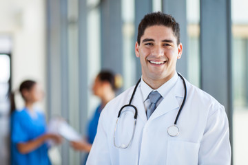 happy male medical doctor portrait in hospital - Powered by Adobe