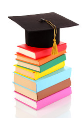 Grad hat with books isolated on white