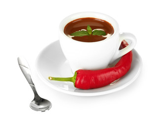 white cup with hot chocolate and chili pepper isolated on white