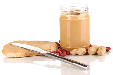 Delicious peanut butter in jar with sandwich isolated on white