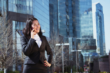 Portrait of a cute business woman over business center on back