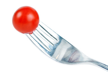 Red ripe cherry tomato and fork, isolated on white