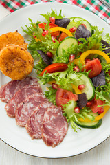 Fresh mixed vegetable salad, sliced sausage and cheese toasts