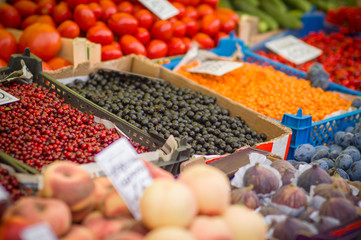 Variety of wild berries on table on city market
