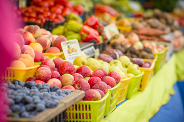 Variety of apples and peaches on city market