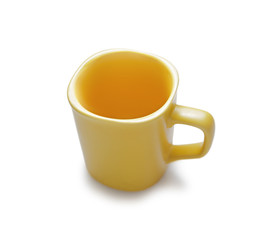 Empty yellow ceramic mug. Isolated on white