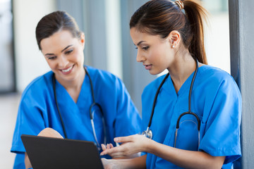 two beautiful female healthcare workers using laptop - 45640028