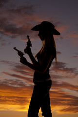 woman with two guns silhouette