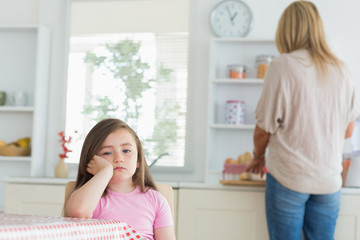 Little girl bored in the kitchen