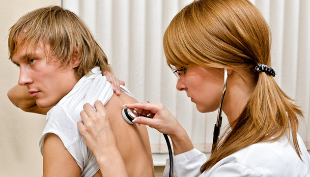 Young female doctor examine male patient with stethoscope