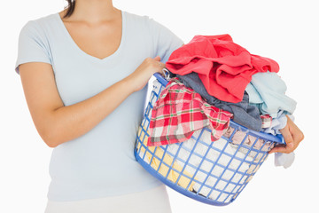 Brunette holding a basket full of laundry