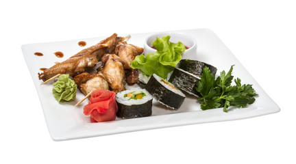 Buffalo chicken wings on plate with sushi