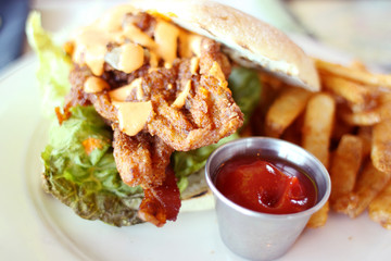 Breaded razor clam sandwich with french fries.