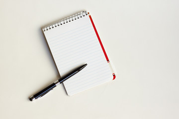 pad and pen against white background