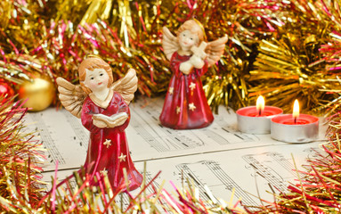 Christmas figurine of angels on a music sheet.