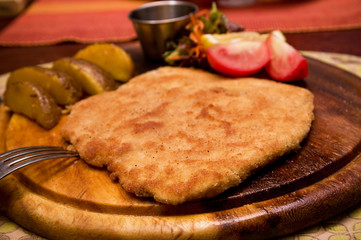 Delicious Pork Chop with potatoes and slices of tomato