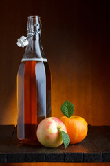 Apple cider bottle with ripe apples