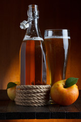 apple cider glass and bottle with apples still life