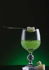 Glass of absinthe with spoon and lump sugar - obrazy, fototapety, plakaty